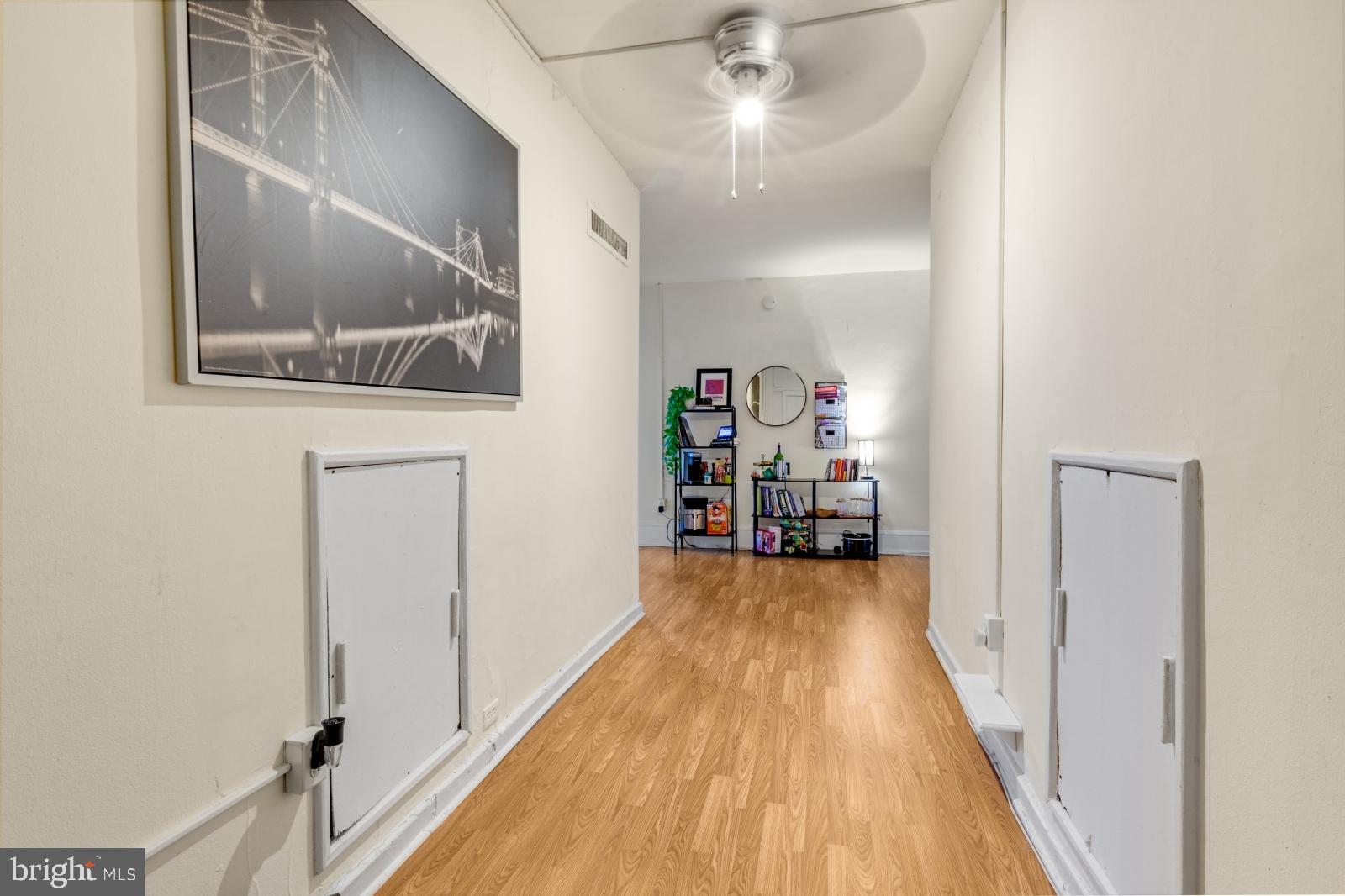 1324 Locust Street, Unit 1503 Philadelphia, PA 19107 - Photo 8 of 38 a view of a hallway with wooden floor and staircase