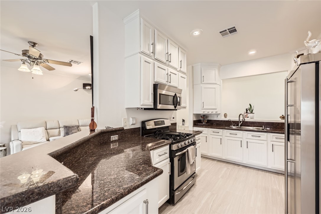 2050 West Warm Springs Road, Unit 3624 Henderson, NV 89014 - Photo 13 of 40 Kitchen with stainless steel appliances, ceiling fan, white cabinets, dark stone countertops, and recessed lighting