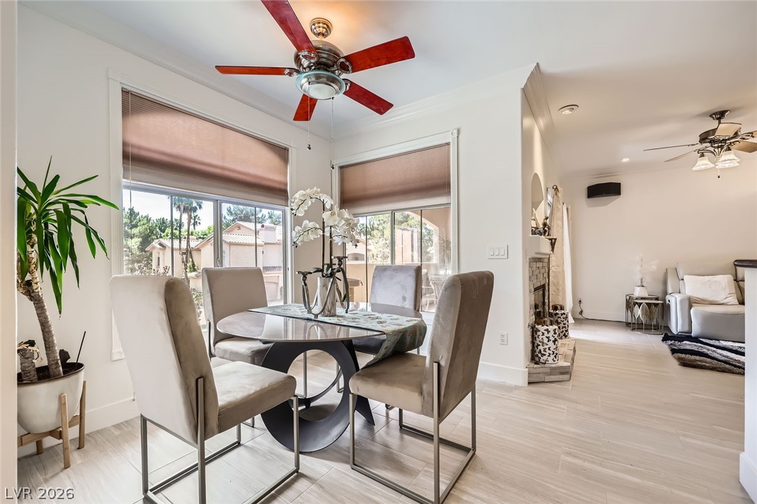 2050 West Warm Springs Road, Unit 3624 Henderson, NV 89014 - Photo 15 of 40 Dining area with a ceiling fan, a stone fireplace, and light wood-style flooring