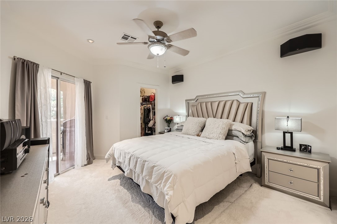 2050 West Warm Springs Road, Unit 3624 Henderson, NV 89014 - Photo 16 of 40 Bedroom with light colored carpet, a walk in closet, access to outside, ornamental molding, and a ceiling fan