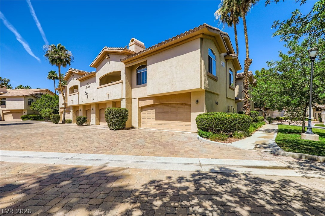 2050 West Warm Springs Road, Unit 3624 Henderson, NV 89014 - Photo 2 of 40 View of front of home with an attached garage, stucco siding, a tile roof, and decorative driveway