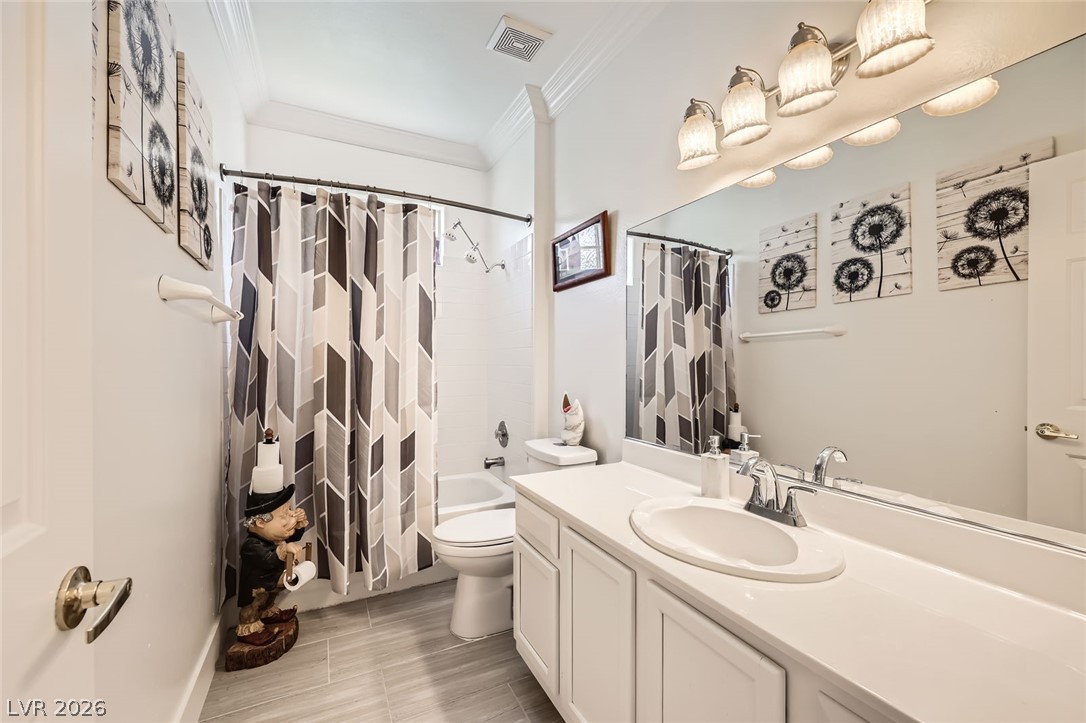2050 West Warm Springs Road, Unit 3624 Henderson, NV 89014 - Photo 25 of 40 Full bathroom featuring crown molding, vanity, and shower / bath combo with shower curtain
