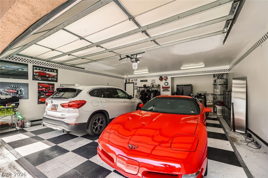 2050 West Warm Springs Road, Unit 3624 Henderson, NV 89014 - Photo 31 of 40 Garage with water heater and freestanding refrigerator