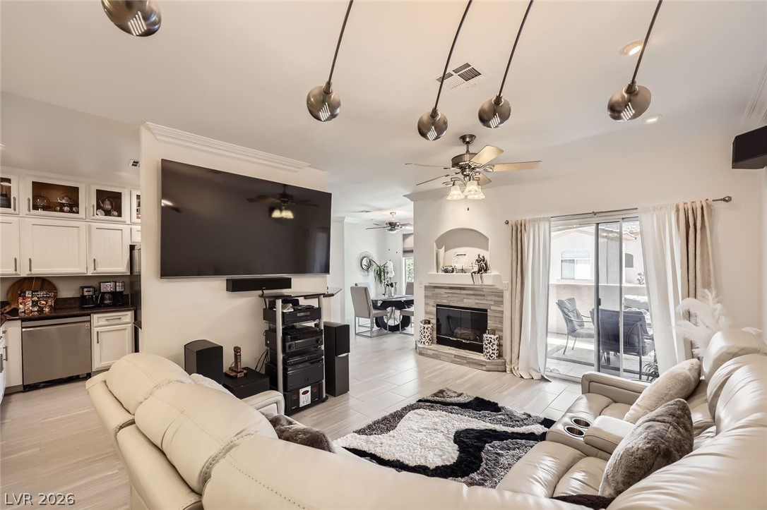 2050 West Warm Springs Road, Unit 3624 Henderson, NV 89014 - Photo 5 of 40 Living area with a ceiling fan, light wood-style flooring, and a tile fireplace