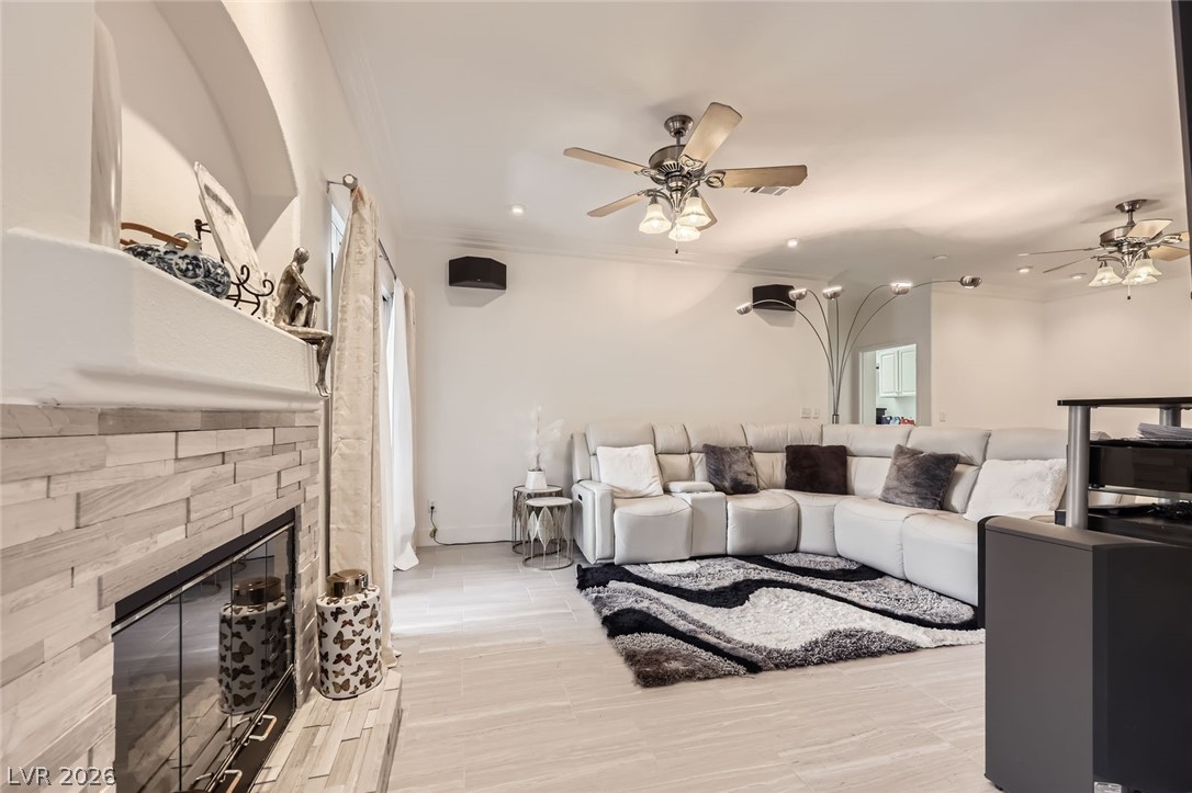 2050 West Warm Springs Road, Unit 3624 Henderson, NV 89014 - Photo 7 of 40 Living area with a ceiling fan, ornamental molding, recessed lighting, and a fireplace