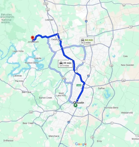 a close up of a white sink sitting under a large umbrella