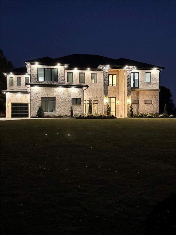 3425 Thompson Mill Road Buford, GA 30519 - Photo 12 of 48 a front view of a house with a garden