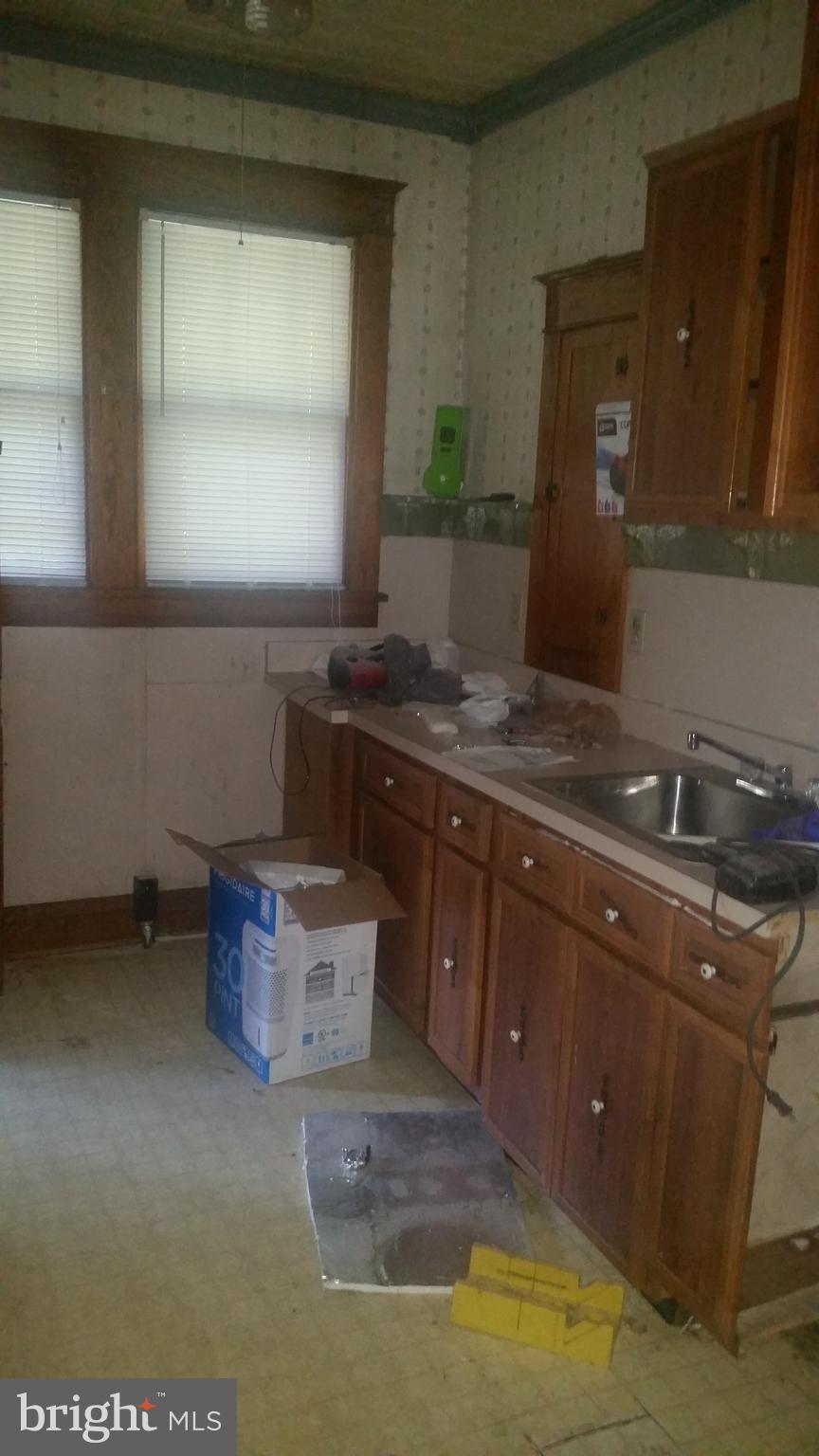 9218 Crandall Road Lanham, MD 20706 - Photo 9 of 12 a room with a sink cabinets and a window