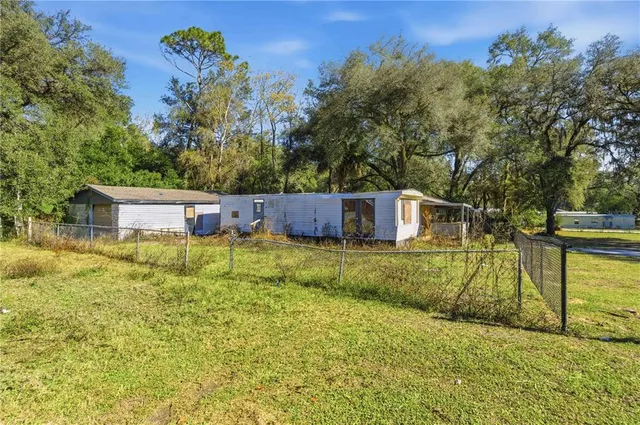 a view of a backyard with trees