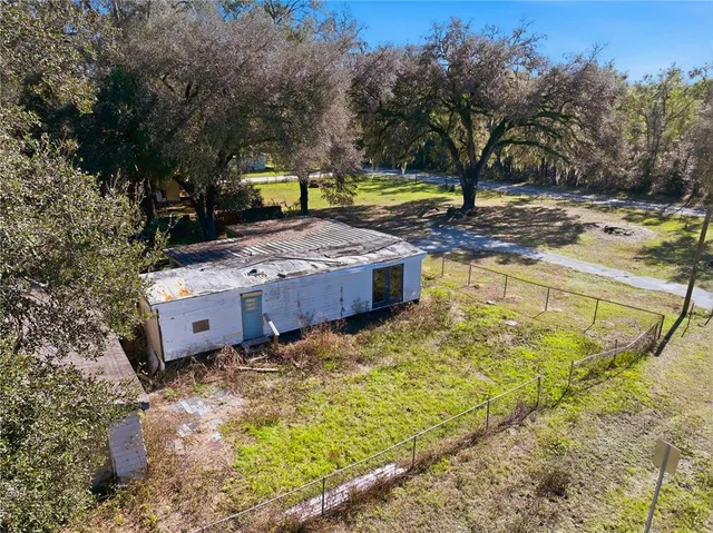 a view of a backyard with sitting area