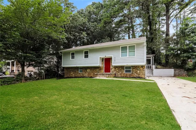 a front view of house with yard and green space
