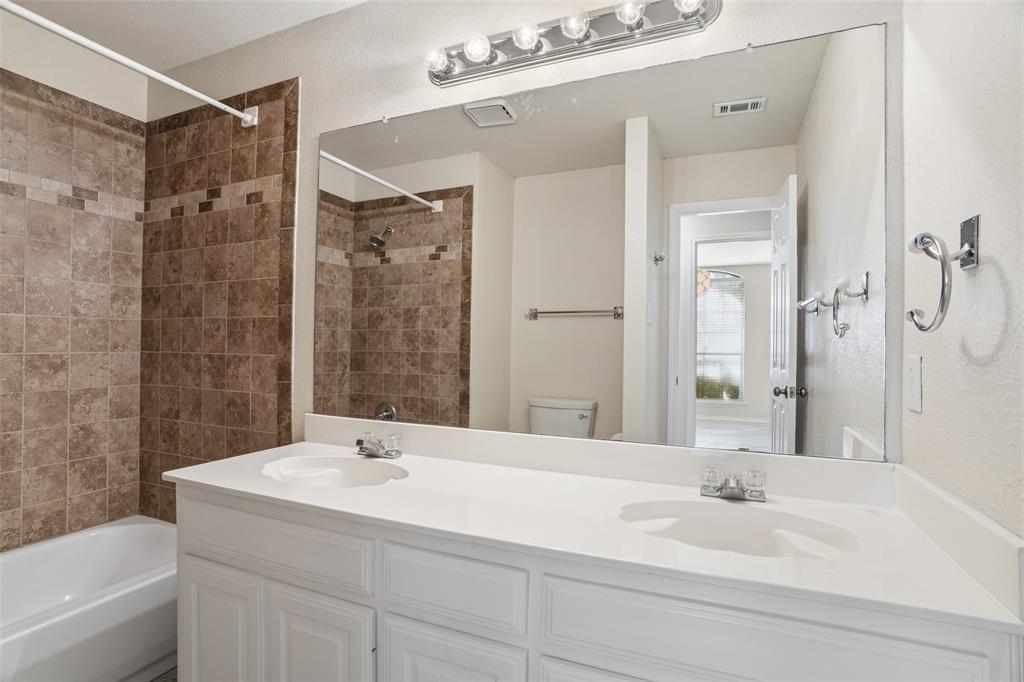1204 Morrow Lane Allen, TX 75002 - Photo 11 of 19 a bathroom with a bathtub shower sink and toilet