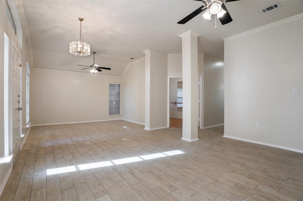 1204 Morrow Lane Allen, TX 75002 - Photo 2 of 19 an empty room with wooden floor fan and window