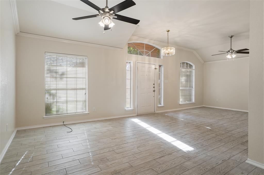 1204 Morrow Lane Allen, TX 75002 - Photo 3 of 19 a view of an empty room with a window and wooden floor
