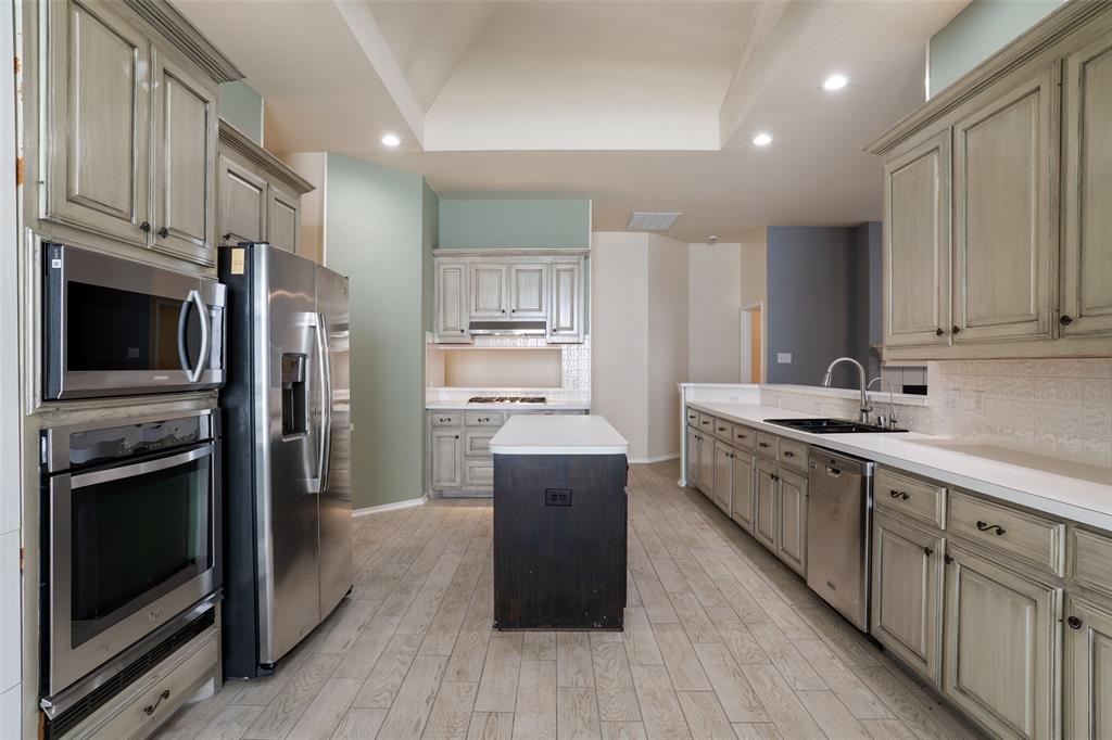 1204 Morrow Lane Allen, TX 75002 - Photo 5 of 19 a kitchen with cabinets and stainless steel appliances