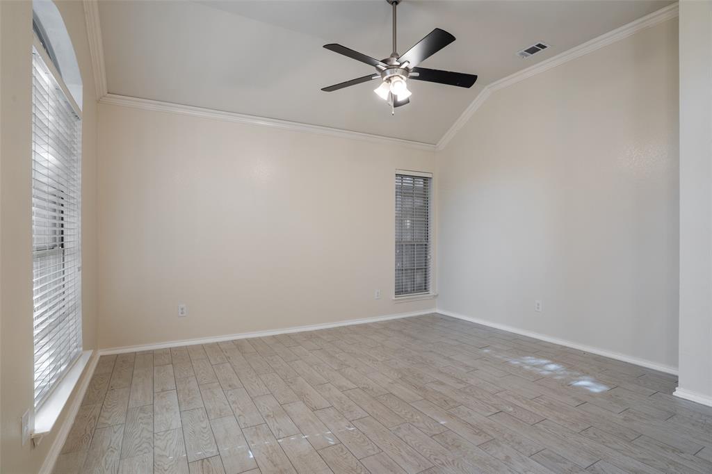 1204 Morrow Lane Allen, TX 75002 - Photo 9 of 19 an empty room with wooden floor chandelier fan and windows