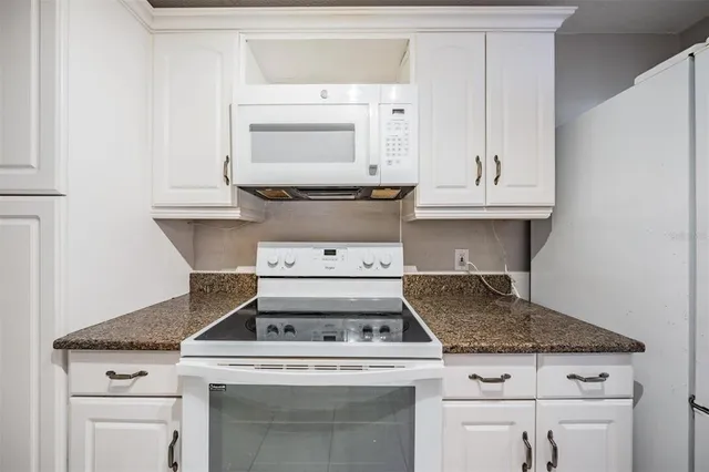 a stove top oven sitting inside of a kitchen
