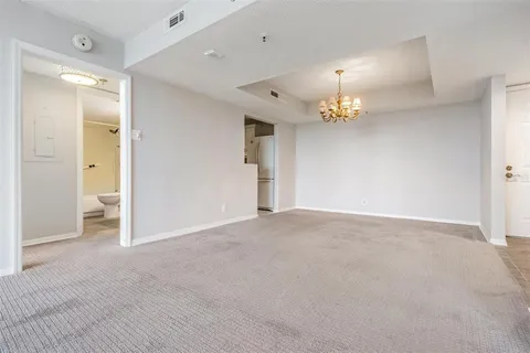 a view of a chandelier in big room and chandelier