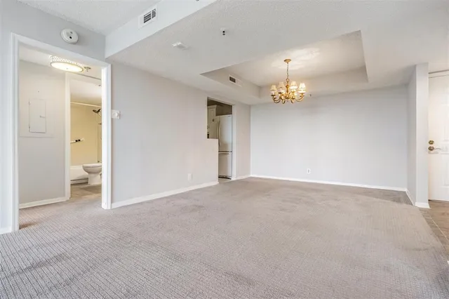 a view of a chandelier in big room and chandelier