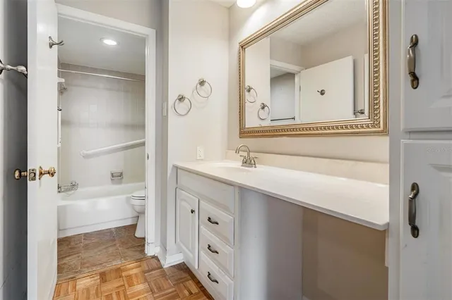 a bathroom with a bathtub shower sink and mirror
