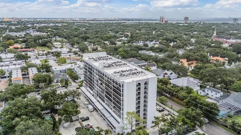an aerial view of a residential apartment building with a city view