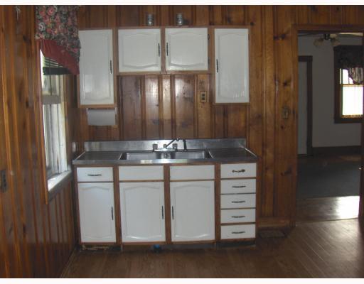 1202 Greenhill Road Pittsburgh, PA 15209 - Photo 6 of 10 Exterior Front. Large Eat-in-Kitchen (15x11) Knotty Pines Walls, new laminate flooring, & behind the louvered doors a Large Pantry with Cabinets & Area for Hanging Coats