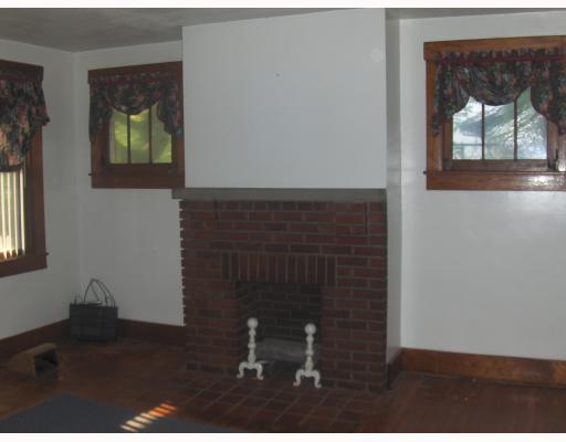 1202 Greenhill Road Pittsburgh, PA 15209 - Photo 7 of 10 Living Room. Charming Living Room (20x14) features Hardwood Flooring, & Decorative Fireplace, Ceiling Fan, Door leadilng to Coverd Front Porch, and Lots of Windows to bring in Natural Light!