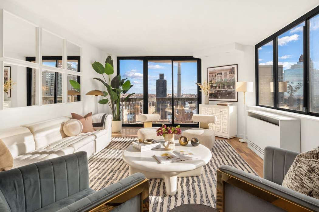a living room with furniture and large windows