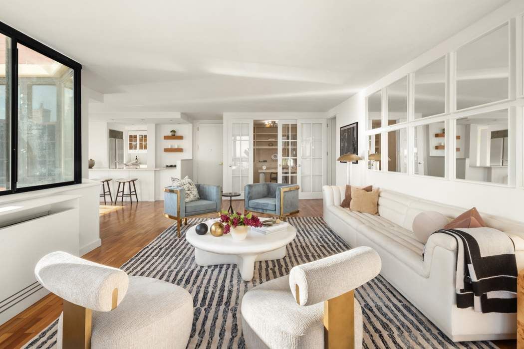 330 East 75th Street, Unit 28BC Manhattan, NY 10021 - Photo 10 of 20 a living room with furniture kitchen and a table