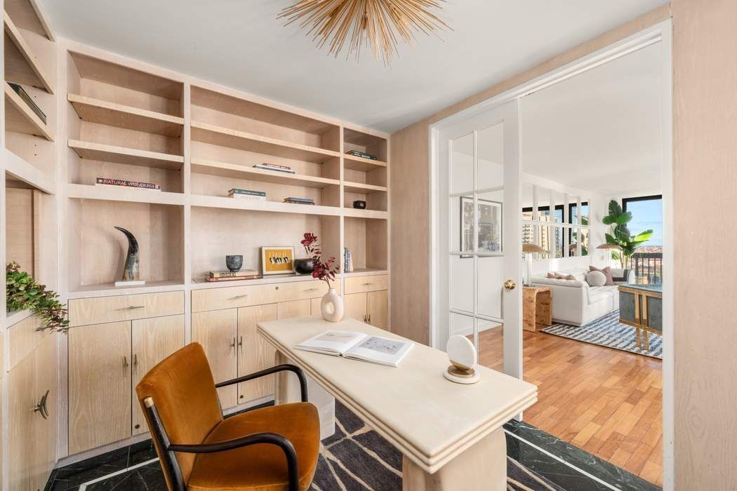 330 East 75th Street, Unit 28BC Manhattan, NY 10021 - Photo 11 of 20 a kitchen with a dining table chairs and white cabinets