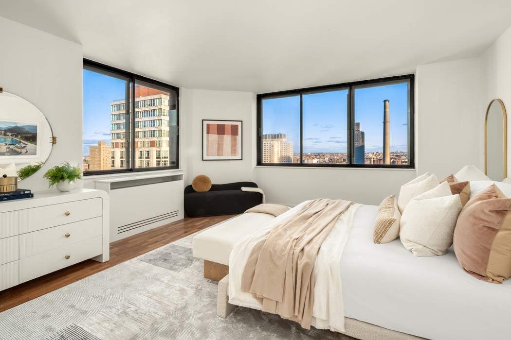 330 East 75th Street, Unit 28BC Manhattan, NY 10021 - Photo 12 of 20 a bedroom with a bed and a large window