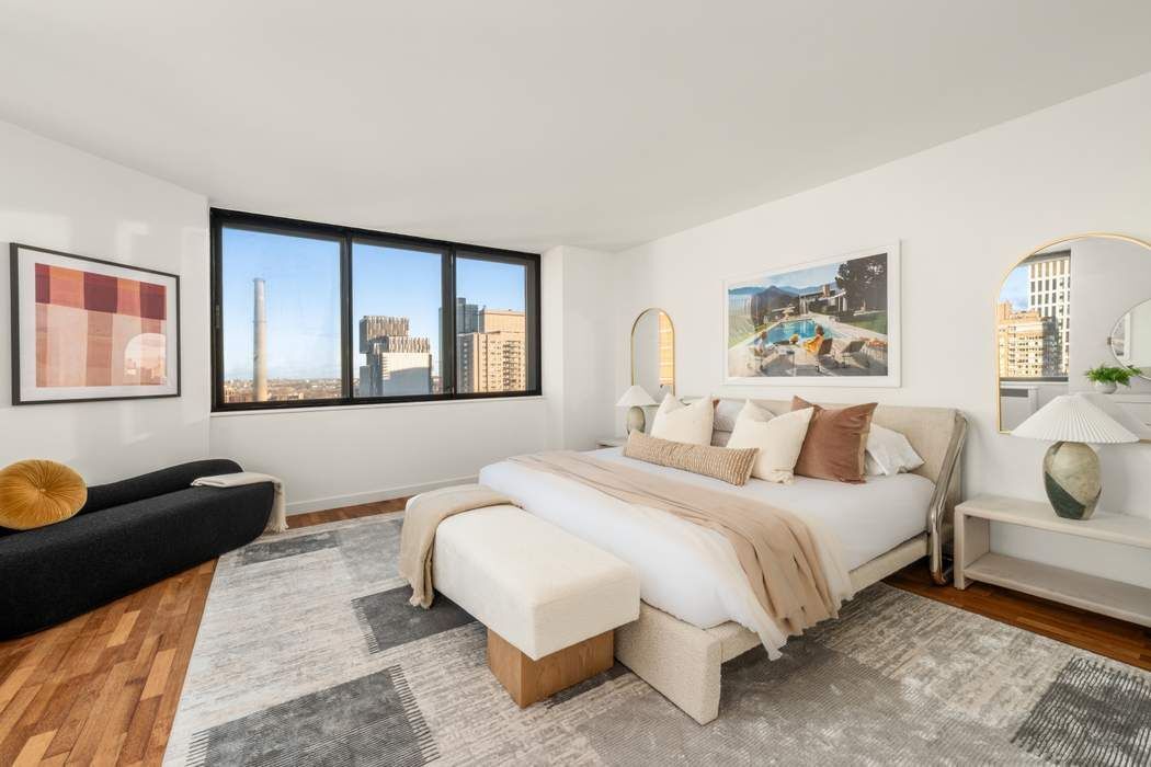 330 East 75th Street, Unit 28BC Manhattan, NY 10021 - Photo 13 of 20 a bedroom with a bed and wooden floor