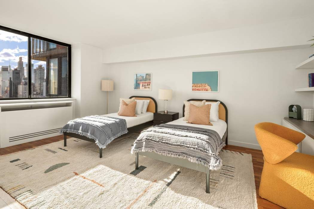 330 East 75th Street, Unit 28BC Manhattan, NY 10021 - Photo 18 of 20 a bedroom with two beds and a window