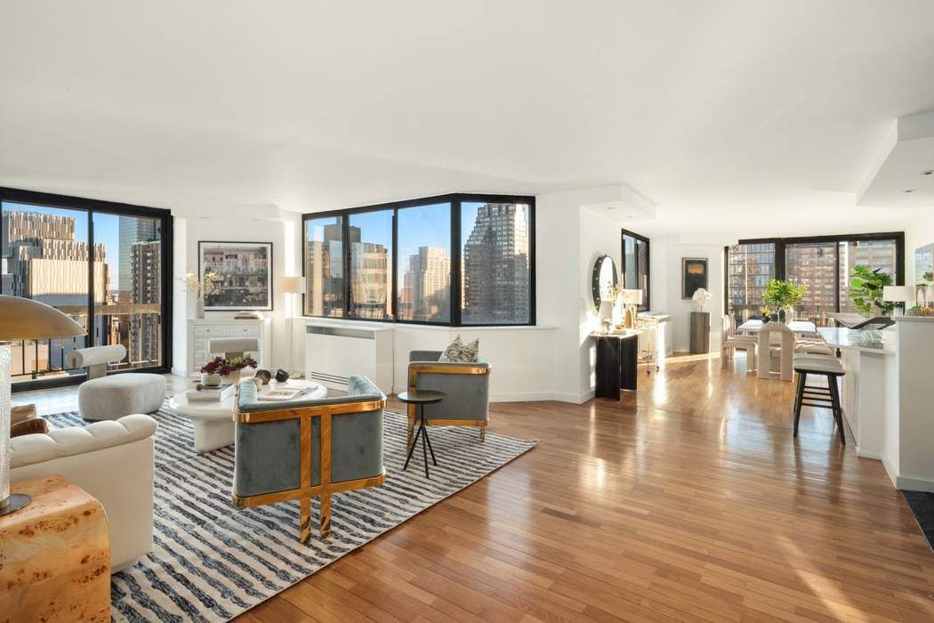 330 East 75th Street, Unit 28BC Manhattan, NY 10021 - Photo 2 of 20 a living room with fireplace furniture and a large window