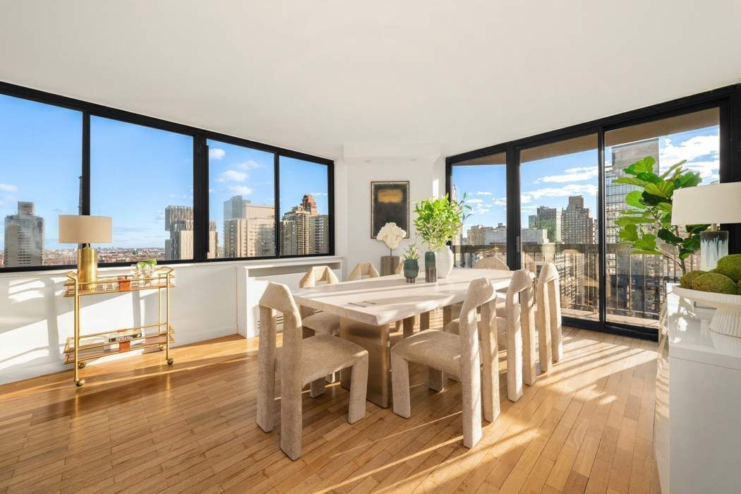330 East 75th Street, Unit 28BC Manhattan, NY 10021 - Photo 5 of 20 a dining room with furniture water view and large windows