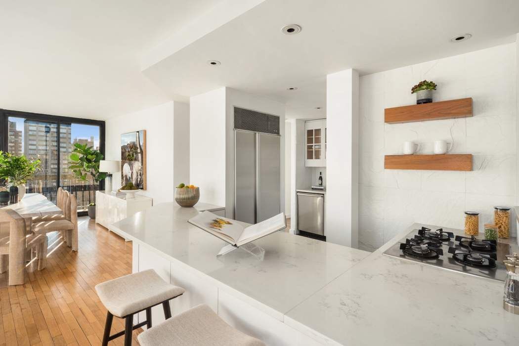 330 East 75th Street, Unit 28BC Manhattan, NY 10021 - Photo 6 of 20 a living room with furniture and a table