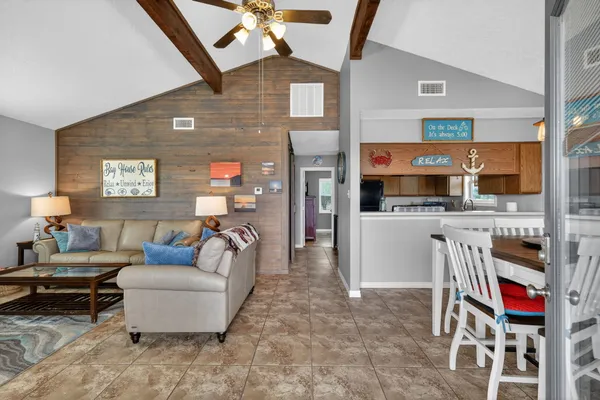 a living room with furniture a flat screen tv and a window