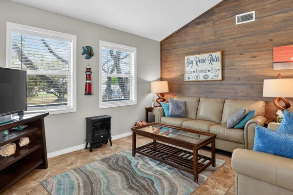 a living room with furniture a dining table and a chandelier