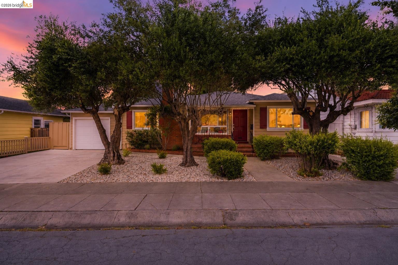 2115 Cleveland Street San Leandro, CA 94577 - Photo 1 of 1 *DIGITALLY ALTERED IMAGE Single-story residence featuring a red entry door, red window shutters, and a well-maintained front yard with mature trees