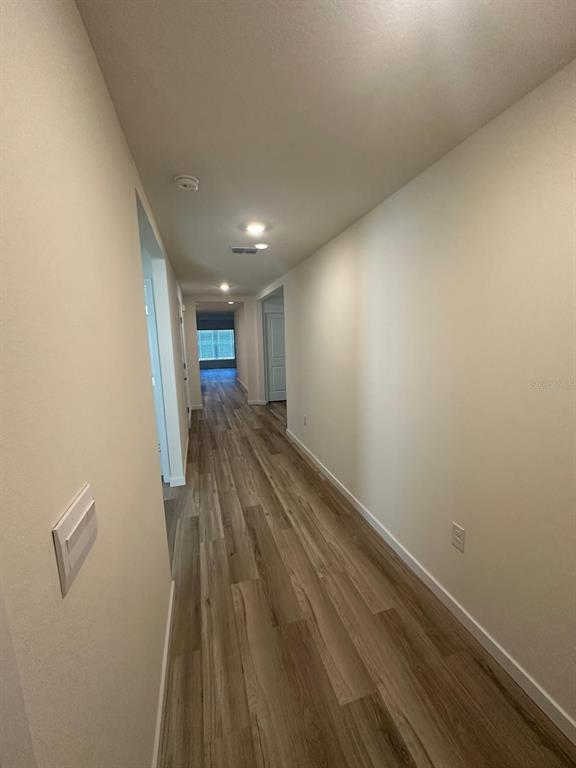 4697 Southwest 89th Street Ocala, FL 34476 - Photo 4 of 11 a view of hallway with wooden floor