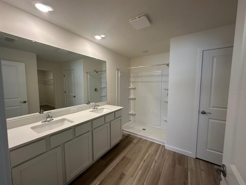 4697 Southwest 89th Street Ocala, FL 34476 - Photo 7 of 11 a bathroom with a double vanity sink and mirror