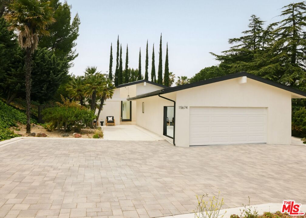 15674 Royal Ridge Road Sherman Oaks, CA 91403 - Photo 1 of 1 a view of a house with a yard and garage