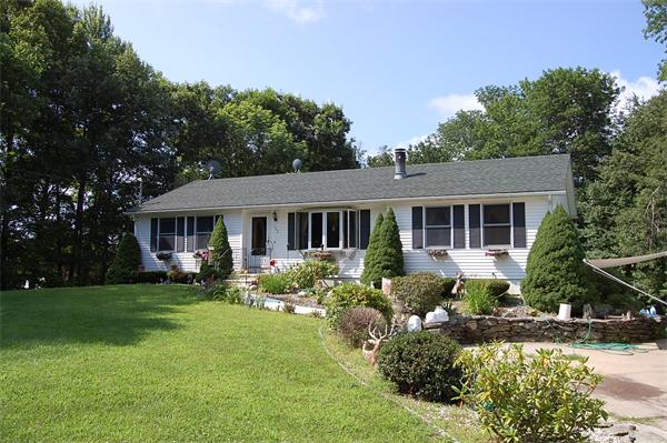 102 Clapp Road Hardwick, MA 01037 - Photo 1 of 11 a front view of house with yard and green space