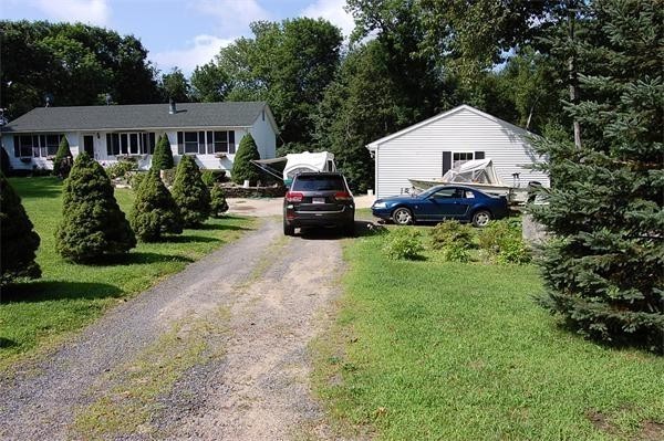 102 Clapp Road Hardwick, MA 01037 - Photo 7 of 11 a view of house with garden and tall trees