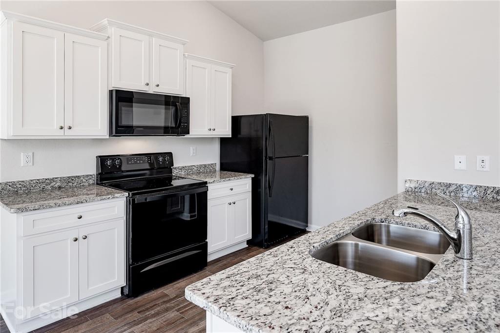 226 Caley Street Kings Mountain, NC 28086 - Photo 4 of 12 a kitchen with stainless steel appliances granite countertop a sink stove and refrigerator