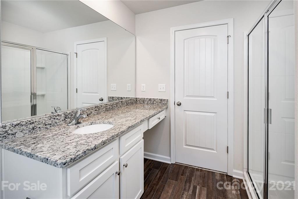 226 Caley Street Kings Mountain, NC 28086 - Photo 10 of 12 a bathroom with a granite countertop sink and a mirror
