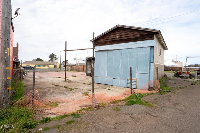 a backyard of a house with a yard and outdoor seating