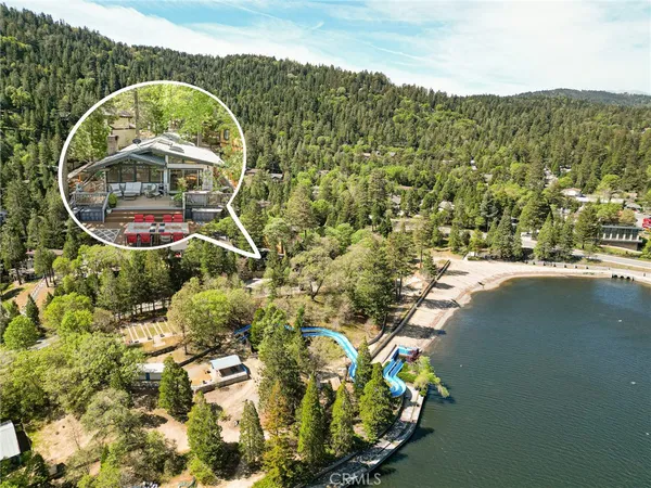 a aerial view of a house with a yard and lake view