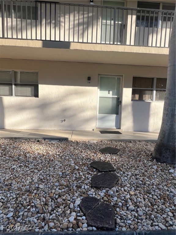 1560 Colonial Boulevard, Unit 134 Fort Myers, FL 33907 - Photo 5 of 12 a view of a hallway with wooden fence