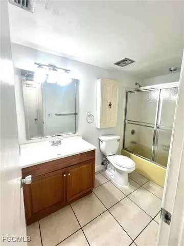 a bathroom with a sink mirror vanity and toilet